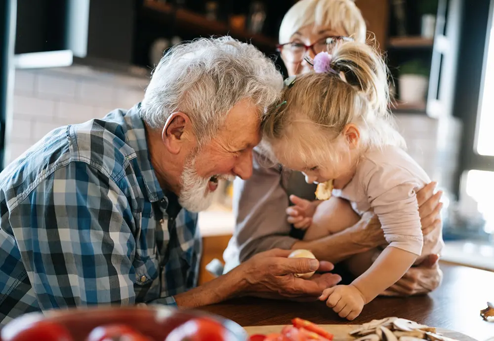 grandpa giving granddaughter ...potato chips? I think?